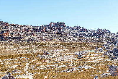 Hiking trail leading across the sandstone plateau toward Wolfberg Arch in the Cederberg Wilderness near Sanddrif, Western Cape, South Africa.