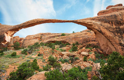 Landscape Arch long thin sandstone arch above rocky slope in Arches National Park Utah