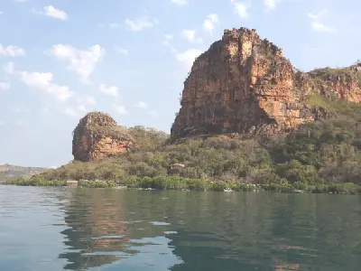 Towering sandstone cliffs rise above the calm waters and mangrove-lined shore of Prince Frederick Harbour.