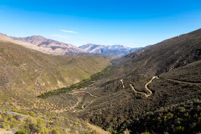 Winding dirt road descending Elands Pass into Gamkaskloof in the rugged Swartberg Mountains of the Klein Karoo, South Africa.