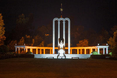 Night view of the illuminated Huguenot Monument in Franschhoek surrounded by gardens in the Cape Winelands of South Africa.