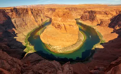 Horseshoe Bend Colorado River midday light full curve sandstone cliffs Page Arizona aerial rim view