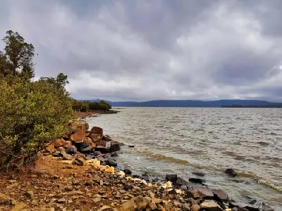Rocky shoreline of Lake Sorell beneath storm clouds in Tasmania’s Central Plateau.