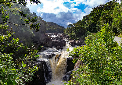 Waterfall flowing through rainforest valley terrain in Ranomafana National Park, Madagascar