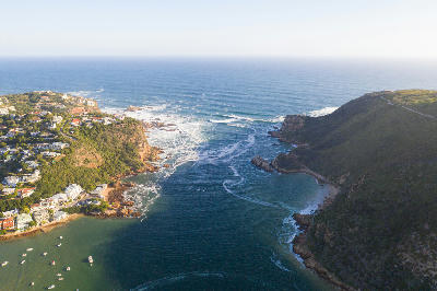 Aerial view of the Knysna Heads, where the Knysna Estuary flows through a narrow channel between rocky headlands into the Indian Ocean on South Africa's Garden Route.