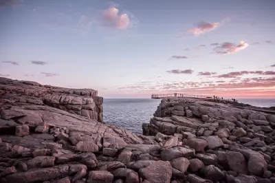 The Gap and its cantilevered lookout at sunset among granite cliffs in Torndirrup National Park near Albany, Western Australia.