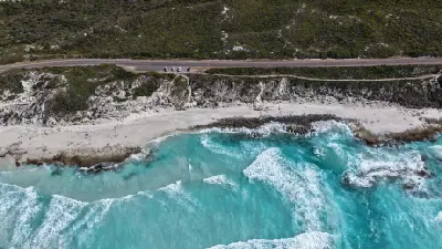 Aerial view of turquoise surf, white sand, coastal heath and Great Ocean Drive near Esperance, Western Australia.