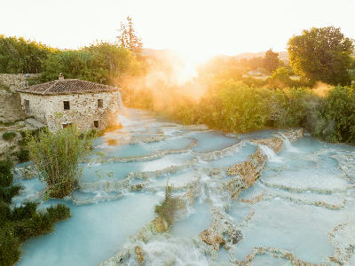 Aerial view of Cascate del Mulino, showing terraced natural hot spring pools near Manciano in southern Tuscany, Italy.