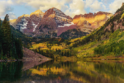 Maroon Bells reflection in Maroon Lake at sunrise with fall colors in Aspen Colorado