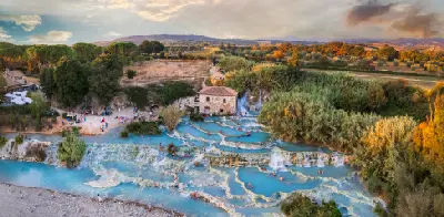 High-angle aerial view of Cascate del Mulino, showing terraced natural thermal pools in the Province of Grosseto, southern Tuscany, Italy.