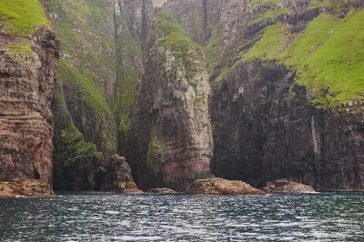 Steep basalt sea cliffs and isolated rock pillar along the Vestmanna bird cliffs, Streymoy, Faroe Islands.