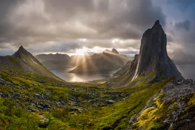Sun rays illuminating Segla mountain and fjord landscape in Senja Norway