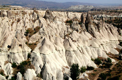 White volcanic ridges and fairy chimneys in White Valley between Göreme and Uçhisar, Cappadocia, Turkey.