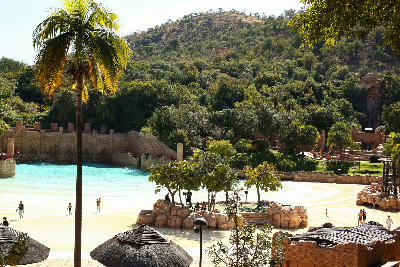The Valley of Waves water park with sandy beach, swimming lagoon and tropical landscaping at Sun City Resort, North West Province, South Africa.