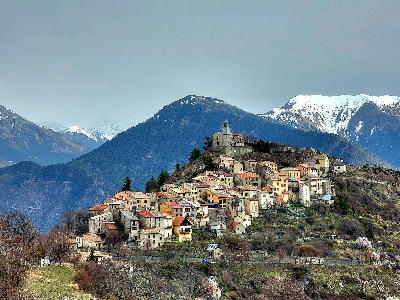 Mountain village perched on a ridge above forested valleys in Alpes-Maritimes near Mercantour