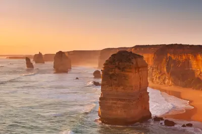 Twelve Apostles limestone sea stacks at sunset on the Great Ocean Road, Victoria, Australia.