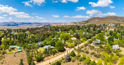 Aerial view of Clarens with tree-lined streets, sandstone hills and the Maluti foothills in the Eastern Highlands of South Africa.
