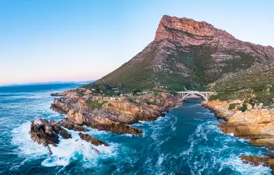 Aerial view of the Kogelberg Biosphere Reserve showing coastal mountains, rocky shoreline and ocean along the Western Cape coast.