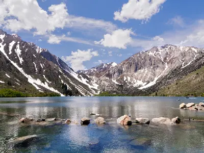 convict lake eastern sierra nevada mountains snow patches kayaks alpine lake california landscape