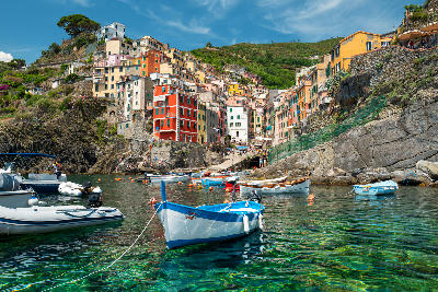 Sea view of Riomaggiore, with colourful village buildings along the coastline of Cinque Terre, Italy.
