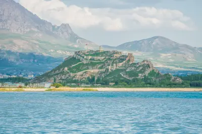 Van Castle on a rocky ridge overlooking Lake Van, with mountains rising behind the historic fortress in eastern Turkey.