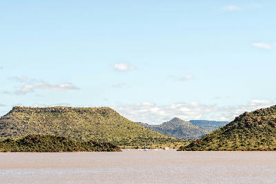 Yachts anchored in a marina on Gariep Dam surrounded by hills and the waters of South Africa's largest reservoir.