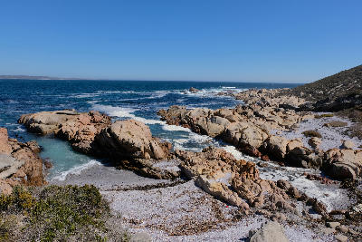 Pink granite rock formations and secluded coves along the Atlantic coastline at Cape Columbine Nature Reserve near Tietiesbaai, South Africa.