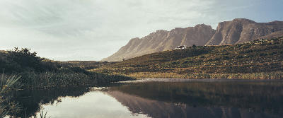 Calm river and mountain reflections at sunset below the Langeberg range near Swellendam, South Africa.