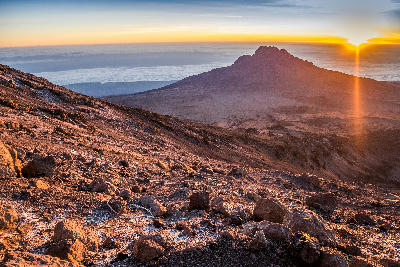 Sunrise illuminating the volcanic slopes of the Saddle with Mawenzi Peak (5,149 m) beyond on Mount Kilimanjaro, Tanzania, at approximately 4,700 metres above sea level.