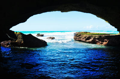 View from inside Waenhuiskrans Cave near Arniston in South Africa, looking out toward rocky tidal pools and the Southern Ocean coastline.