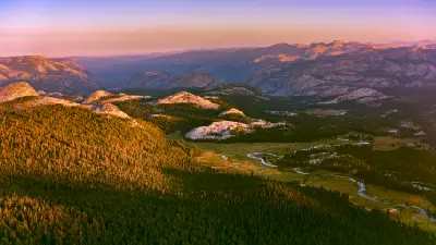Tuolumne River winding through Tuolumne Meadows at sunset in Yosemite National Park, California.