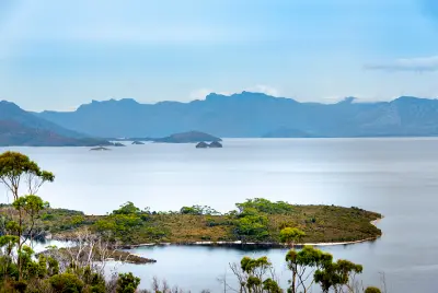 Lake Pedder with small islands and rugged mountain ranges in Southwest National Park, Tasmania, Australia