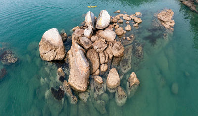 Aerial view of Split Apple Rock surrounded by turquoise water in Tasman Bay, New Zealand.