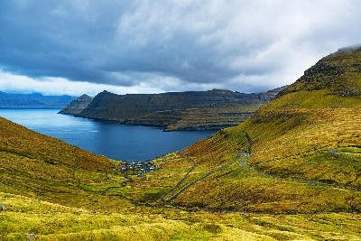Mountain road leading down to Funningur village and Funningsfjørður fjord on Eysturoy, Faroe Islands.