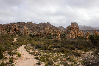 Hiking trail passing through sandstone rock formations in the Cederberg Mountains, South Africa.