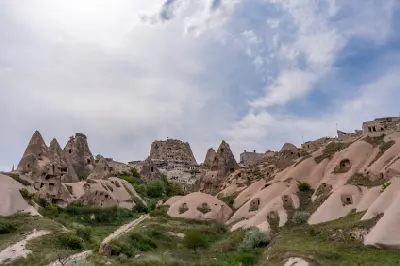 Fairy chimneys and rock-cut dwellings below Uçhisar Castle in Pigeon Valley, Cappadocia, Turkey.