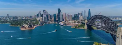 Aerial panorama of Circular Quay with the Sydney Opera House, Harbour Bridge, CBD skyline, ferries and boats across Sydney Harbour.