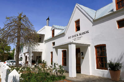 White Cape Dutch style buildings and historic guesthouse architecture in Stellenbosch Town Centre, Western Cape wine region, South Africa.