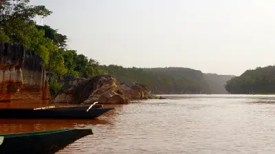 Traditional boats on the Manambolo River below the limestone cliffs of Tsingy de Bemaraha, Madagascar