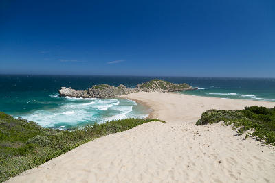View across the sandy dunes and rocky headland of Robberg Peninsula near Plettenberg Bay, South Africa.