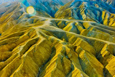 Close-up of Zabriskie Point badlands in Death Valley National Park California showing textured ridges and abstract erosion patterns