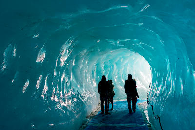 Visitors inside an ice cave tunnel in the Mer de Glace glacier near Chamonix.