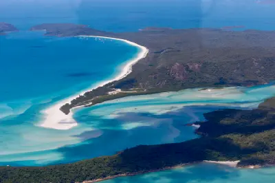 Aerial view of Hill Inlet and the long white curve of Whitehaven Beach on Whitsunday Island, Queensland.