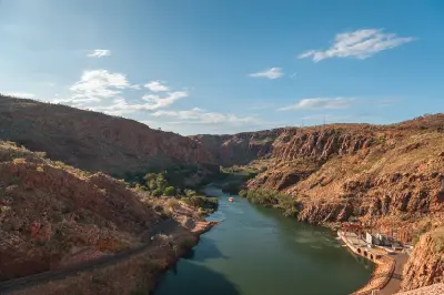 Water below the Lake Argyle dam winds through steep red-rock walls and rugged Kimberley terrain.