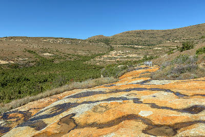 Orange sandstone formations and mountain scenery along the Porcupine Trail in the Clarens and Eastern Highlands of the Free State.