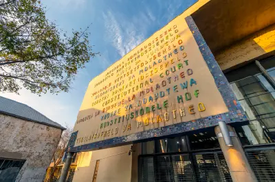 Facade of the Constitutional Court at Constitution Hill displaying multilingual signage in Johannesburg.