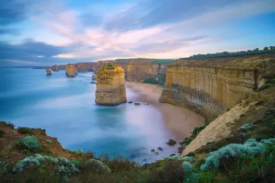 Long-exposure sunrise view of the Twelve Apostles and limestone cliffs on the Great Ocean Road, Victoria.