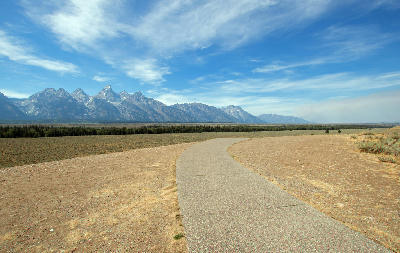 View of the Teton Range from Glacier View Turnout with a curving path in the foreground, Grand Teton National Park, Wyoming, USA.