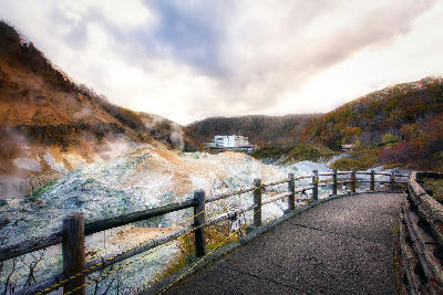 Boardwalk overlooking steaming geothermal vents in Jigokudani Hell Valley in Noboribetsu, Hokkaido, Japan.