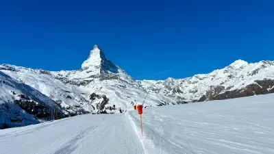 Matterhorn peak viewed from a snow-covered ski slope above Zermatt, Switzerland.